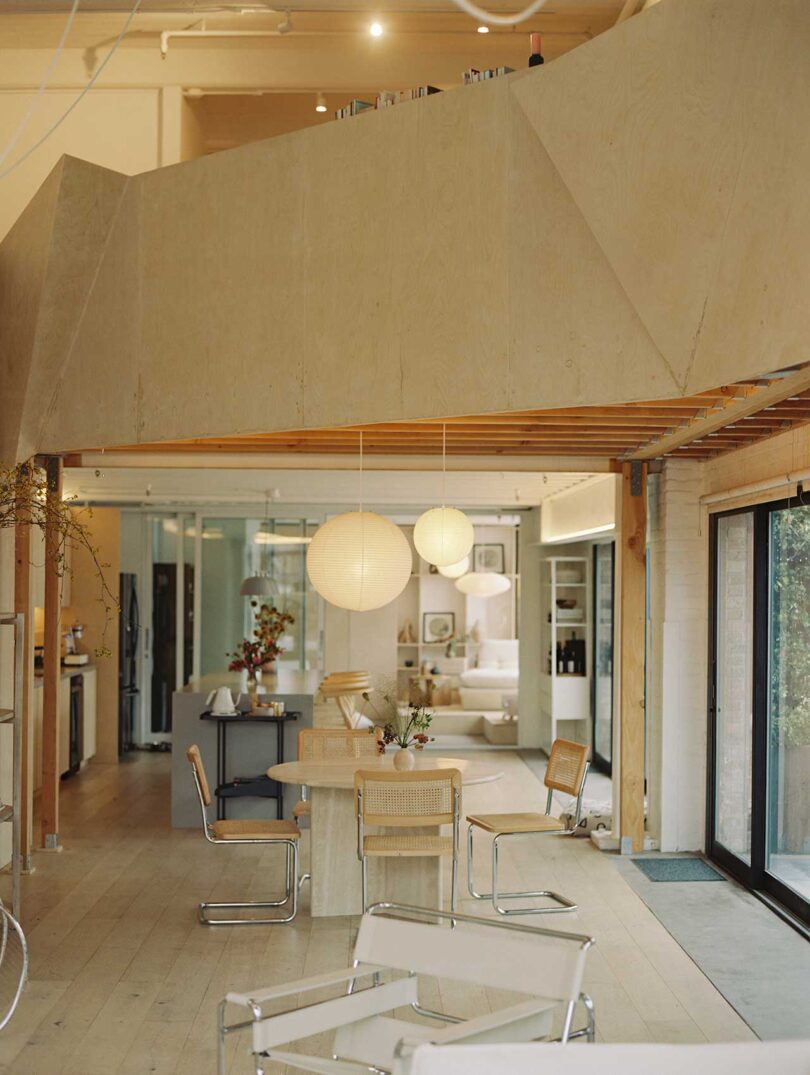 interior shot of modern living space with high ceilings and dining table