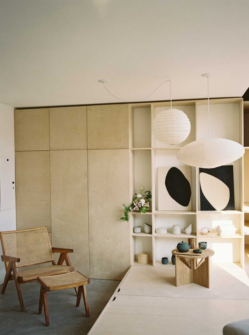 interior shot of modern space with chair, table and hanging white pendants