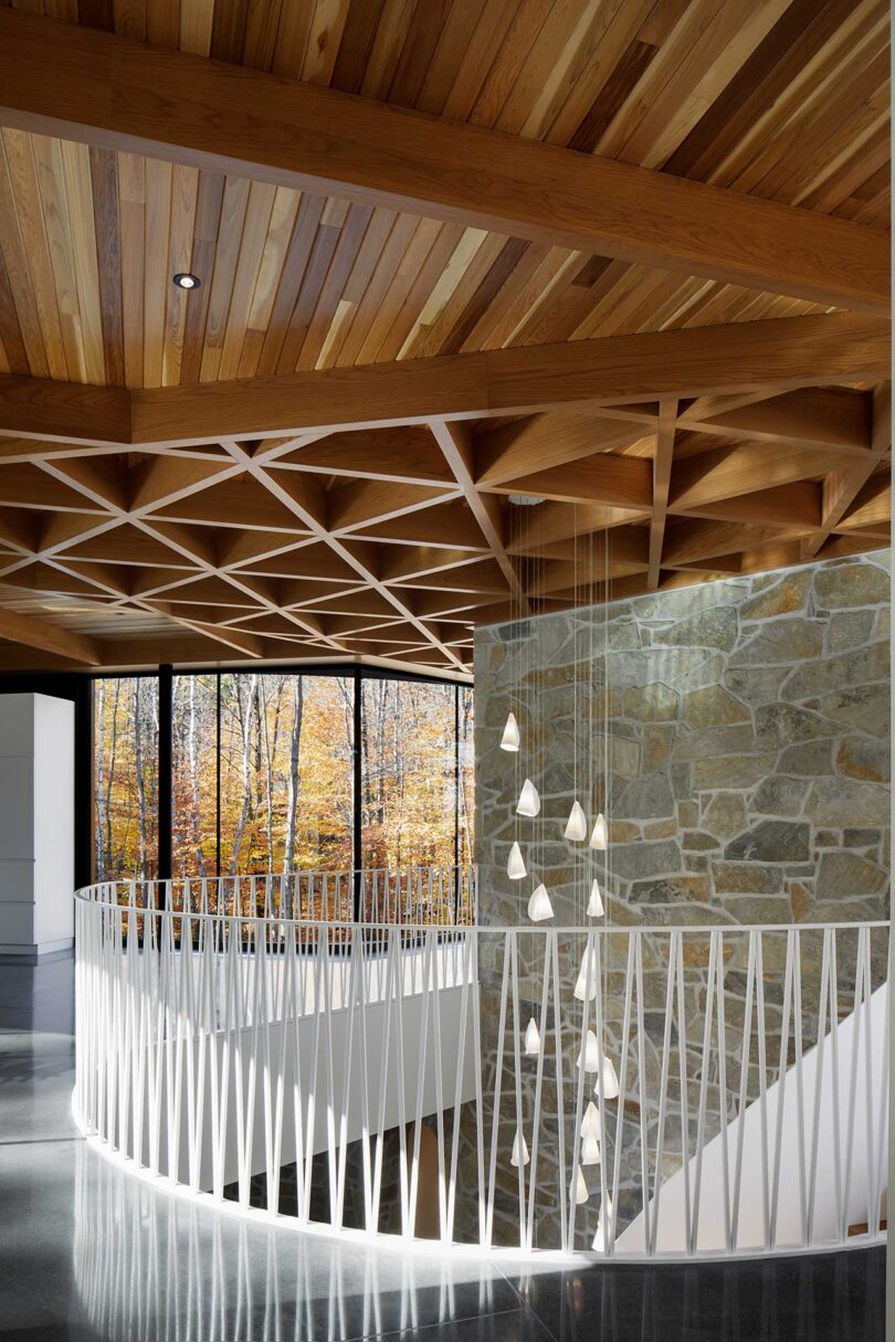 upper interior view of modern house with circular opening for curved staircase and wood ceiling