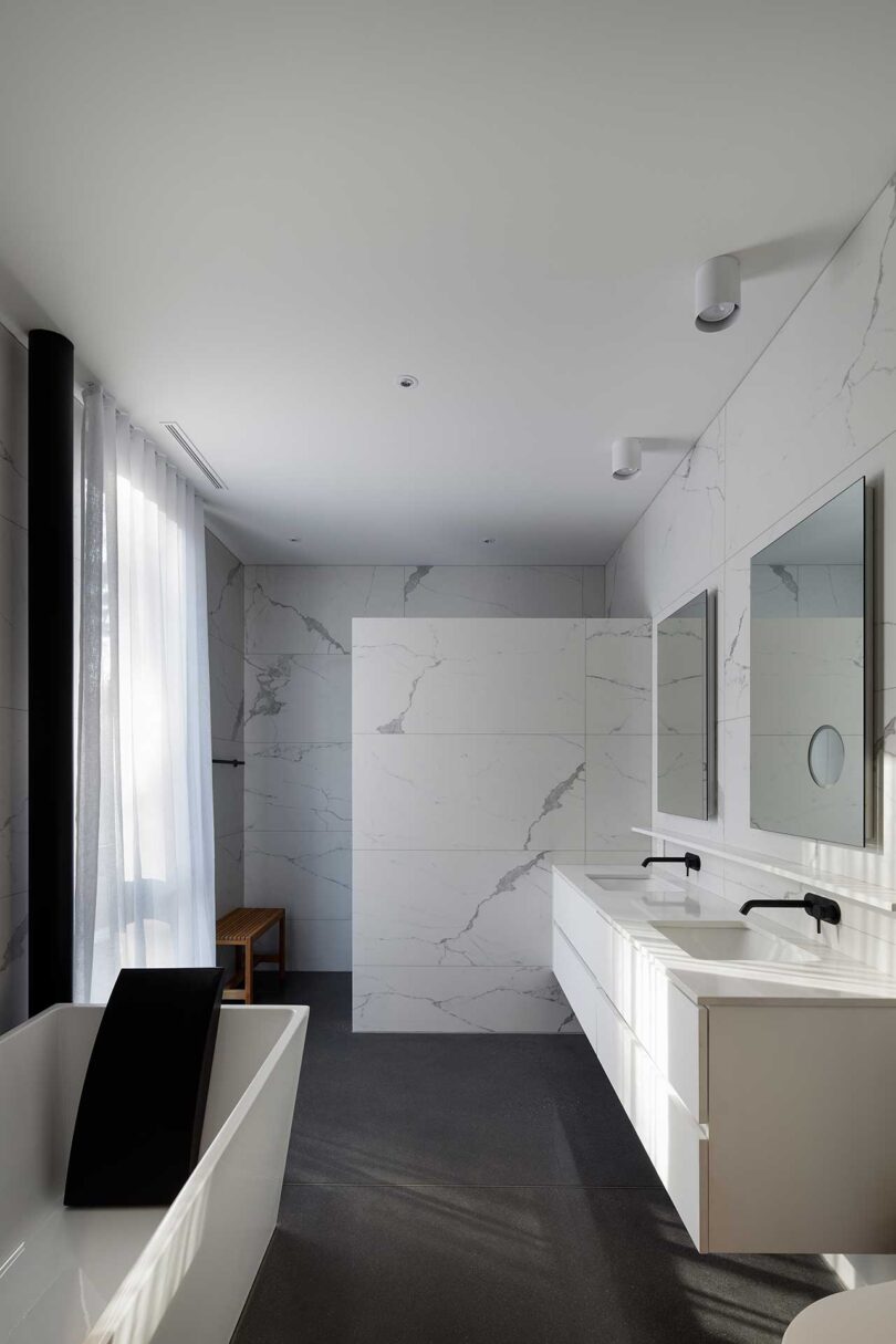 interior view of modern bathroom with white marbled surfaces