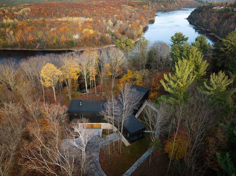 elevated sky view of exterior view of modern house with stone ground level and wood and glass upper level