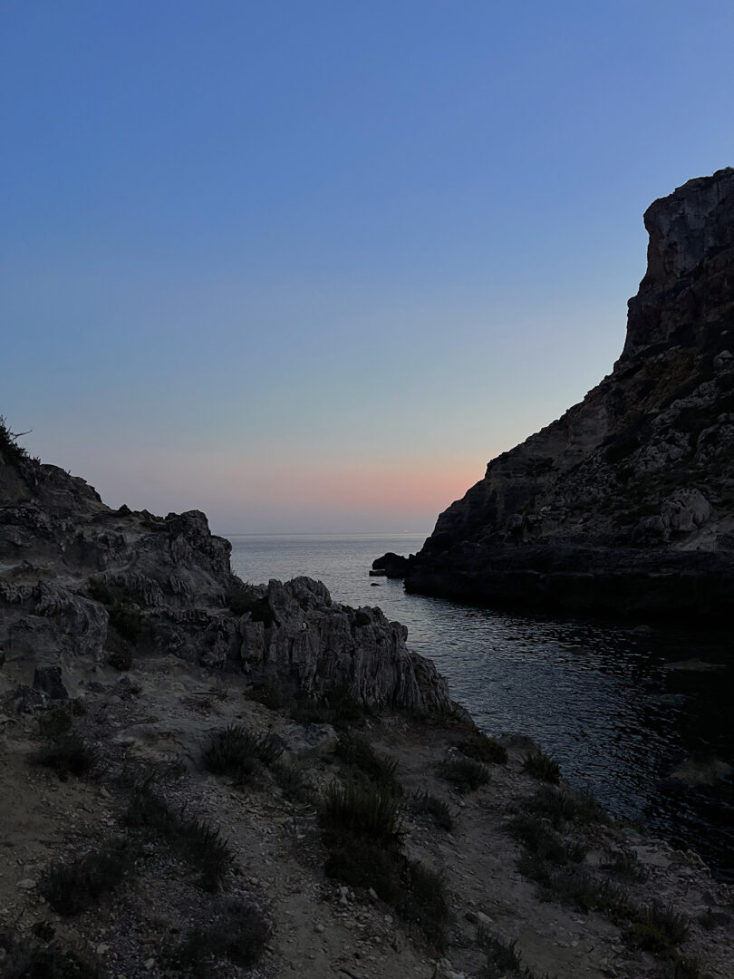 a body of water between two mountains at dusk