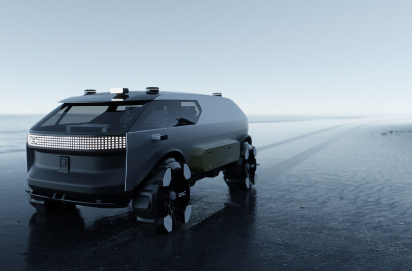 Modern all-terrain van traveling across low tide coastline with tire tracks in the distance