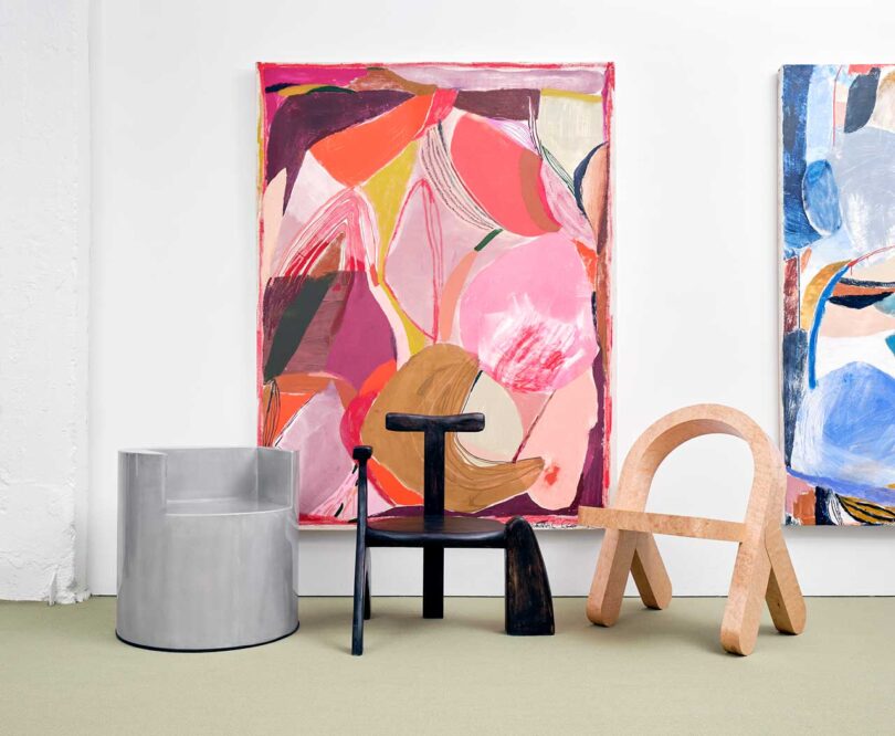 exhibition vignette with colorful abstract art and modern chairs