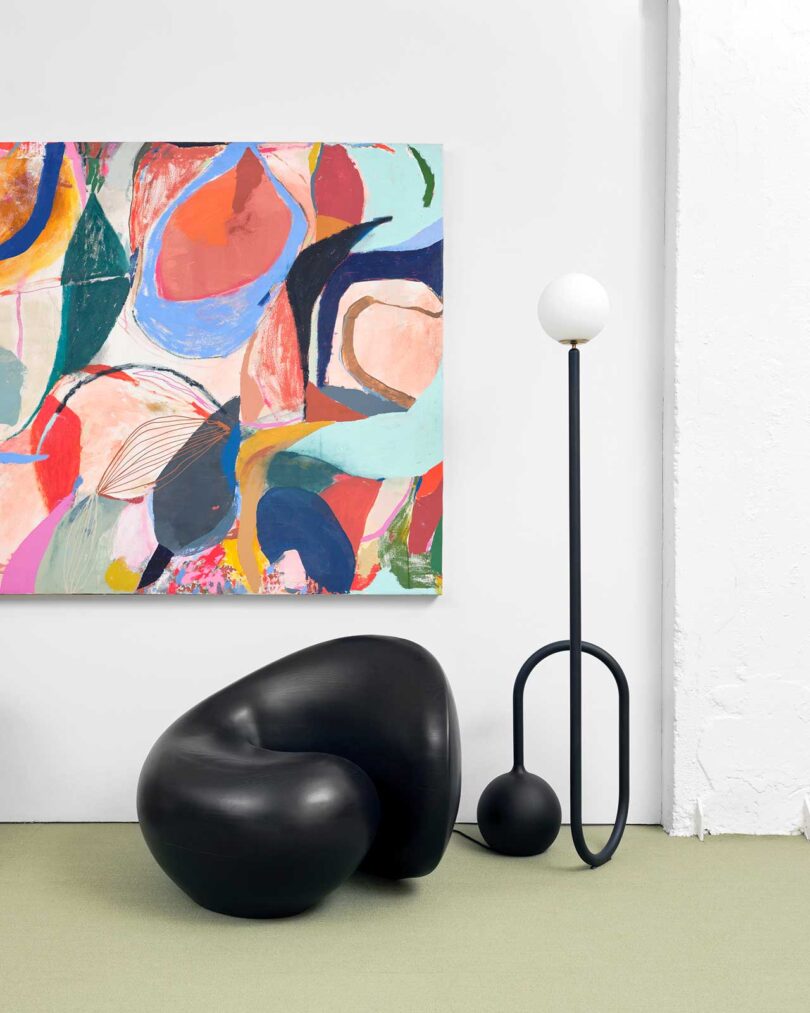 exhibition vignette with colorful abstract art and modern chairs