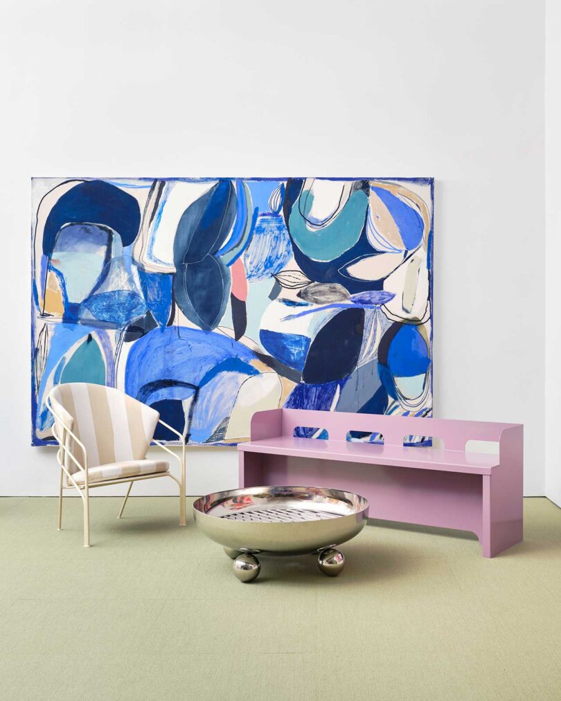 exhibition vignette with colorful abstract art and modern chairs