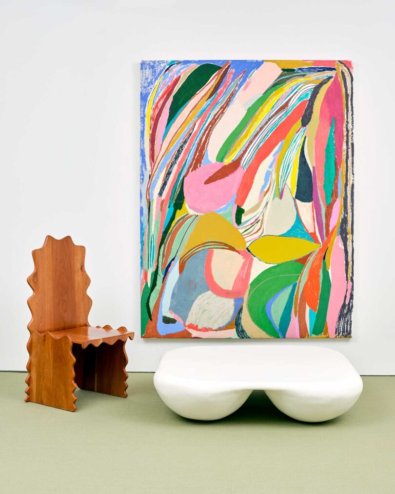 exhibition vignette with colorful abstract art and modern chairs