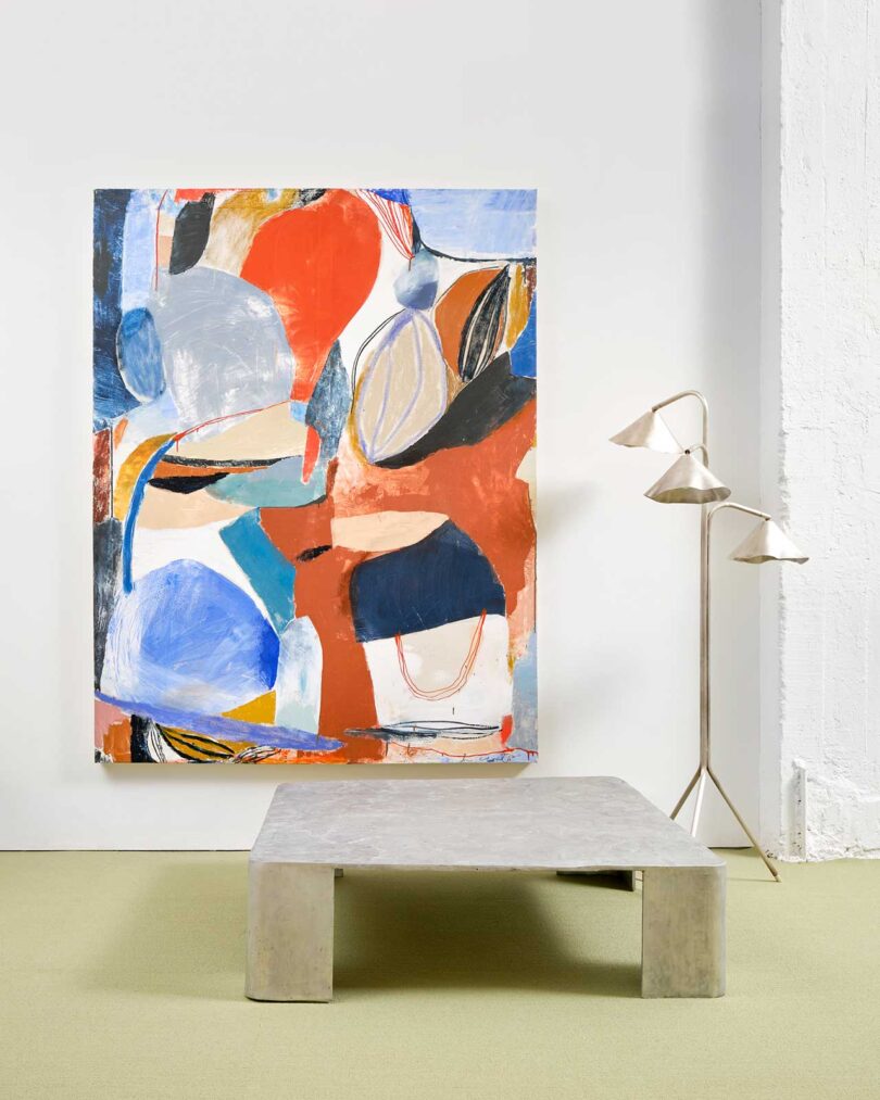 exhibition vignette with colorful abstract art and modern chairs