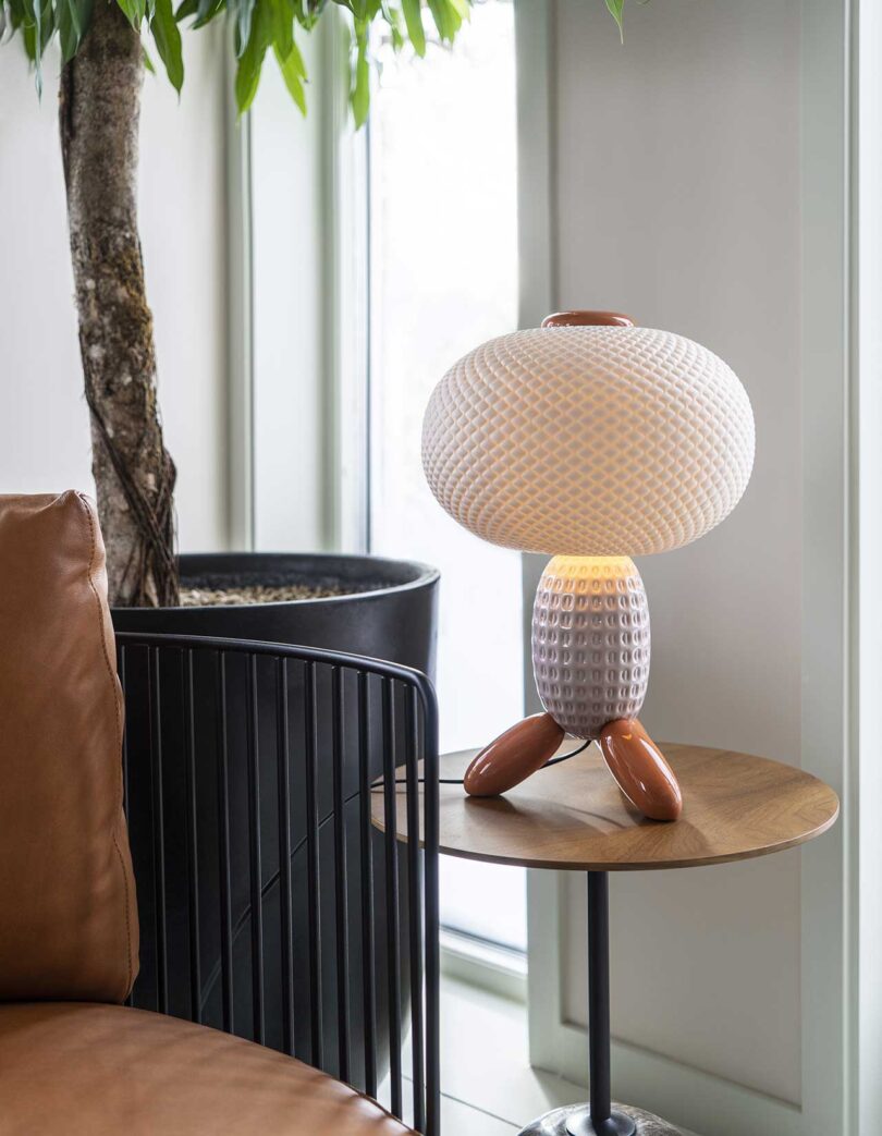 closeup vignette of seating area with unique colorful glass lamp