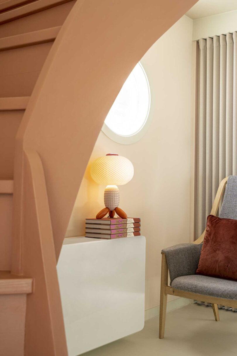 interior view into a room with a chair and unique glass lamp