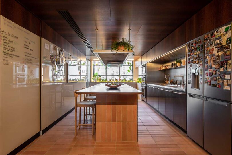 long view of modern kitchen with windows at the end