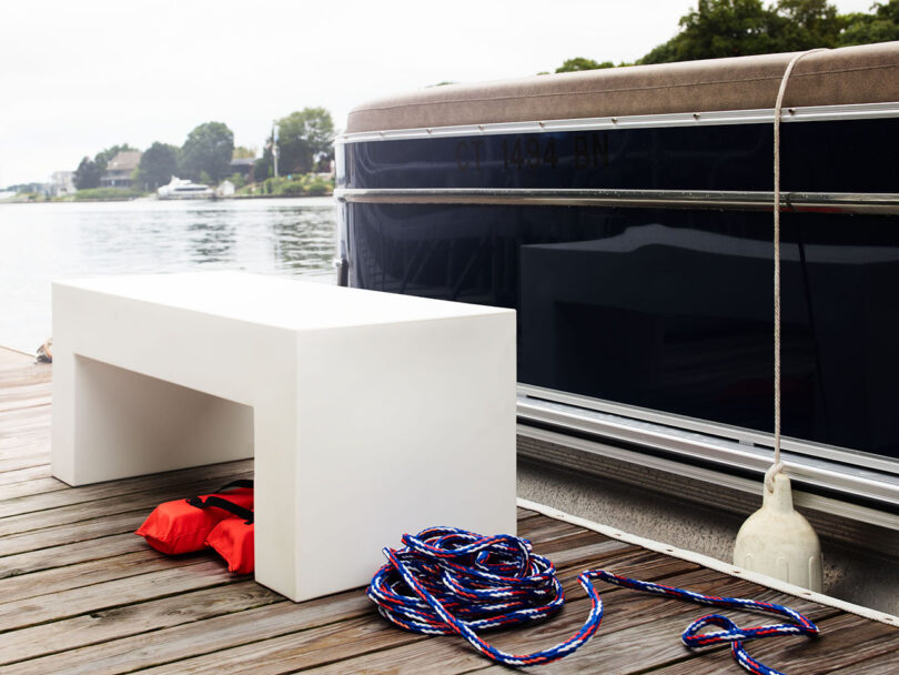 minimal modern white outdoor bench on a dock