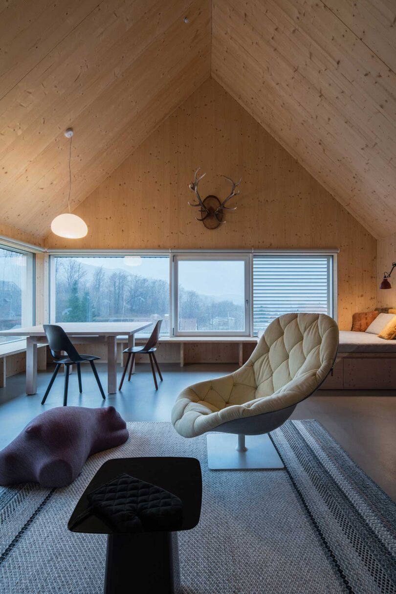 interior shot of modern living space with wooden pitched roof and modern furnishings