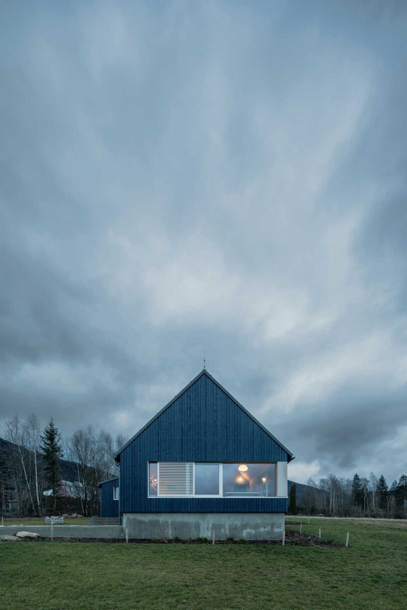 end view of exterior of modern blue cabin