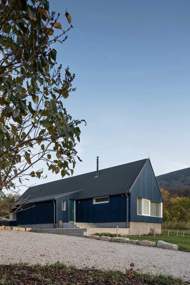 corner view of exterior of modern blue cabin