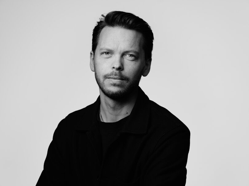 black and white portrait of light-skinned man with dark hair and facial hair