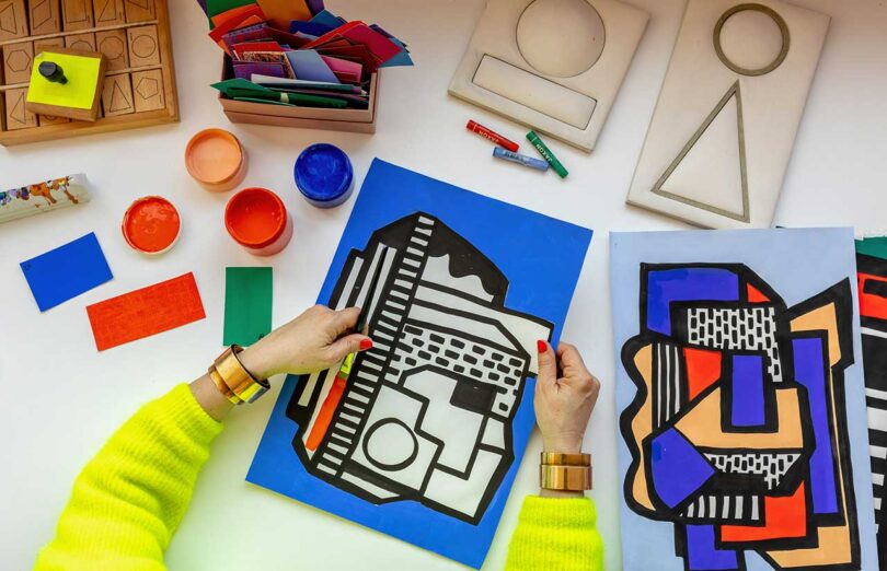 overhead view of artists hands working on geometric artwork