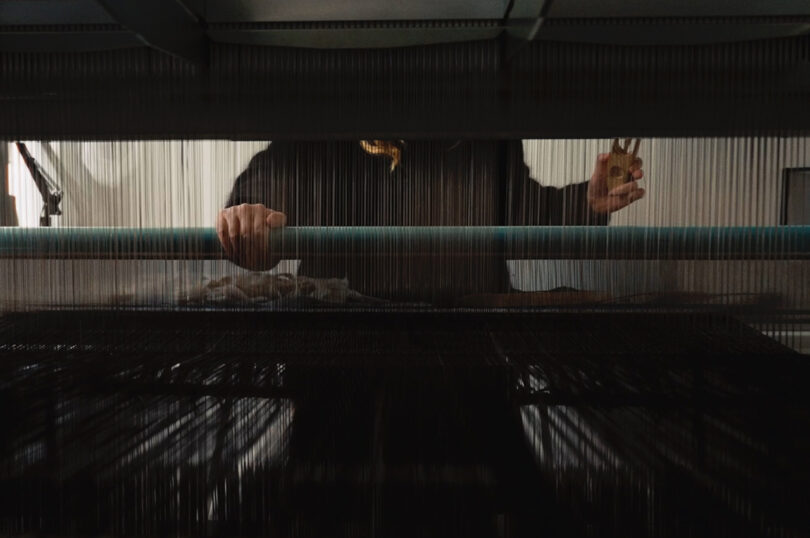 low angle view of a person working on a loom