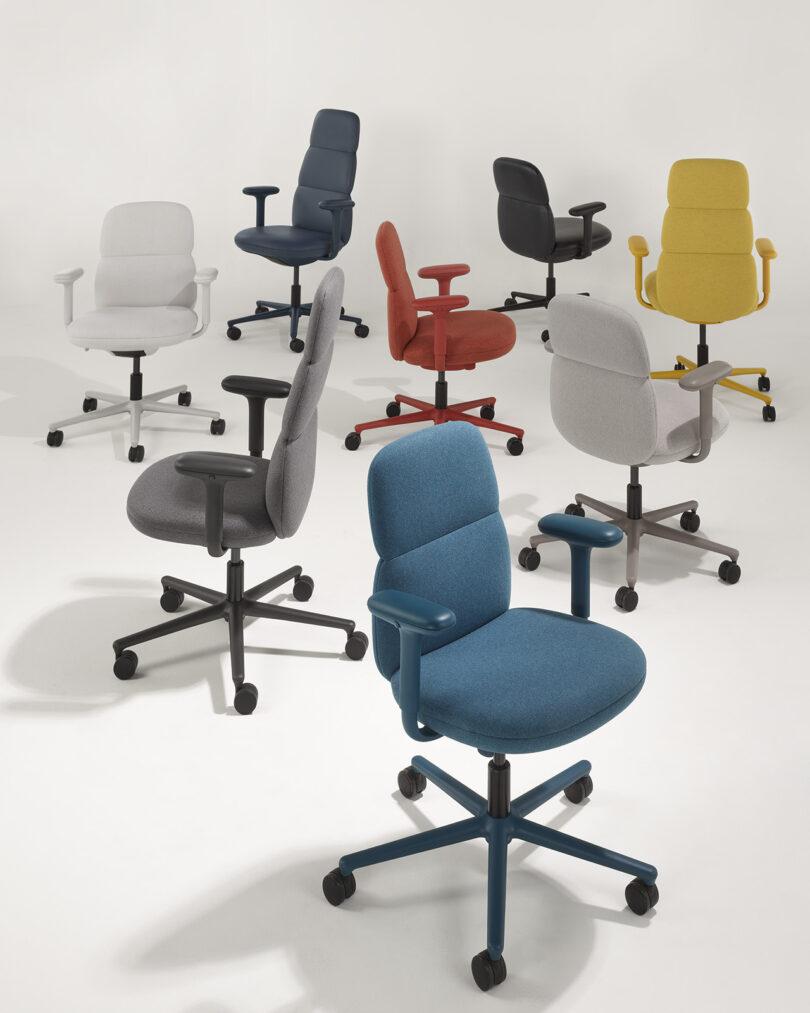 All eight different Asari chair color options, with white, beige, dark grey, blue, teal, black, yellow and red upholstery.