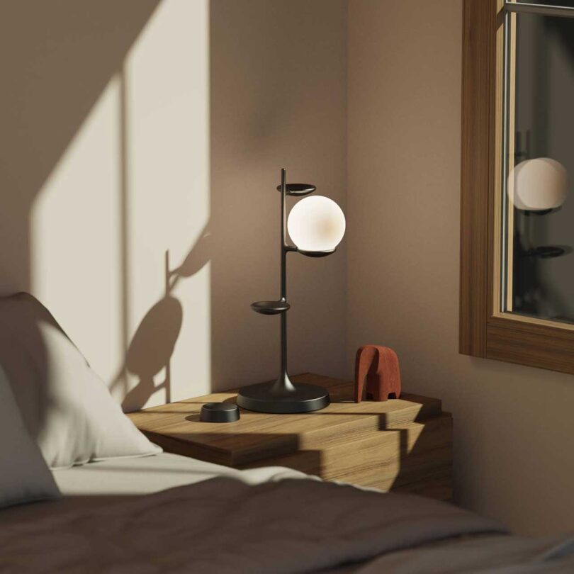 corner of a bedroom with globe lamp on table