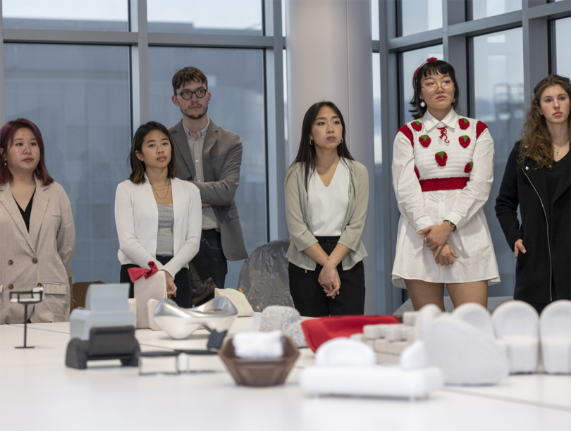 scale models of furniture surrounded by students