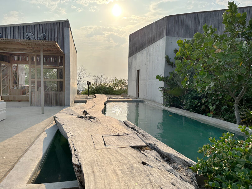 Casa Naila's courtyard bridge and pool with afternoon sun in skies.